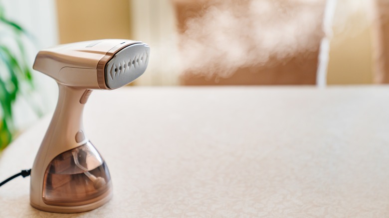 hand-held steamer making steam