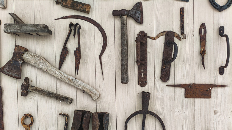 Wall of old rusty garden tools