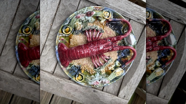 A colorful lobster majolica platter on wooden box