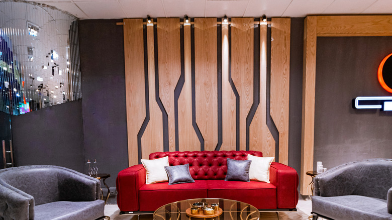 An eclectic living room with wood panels.