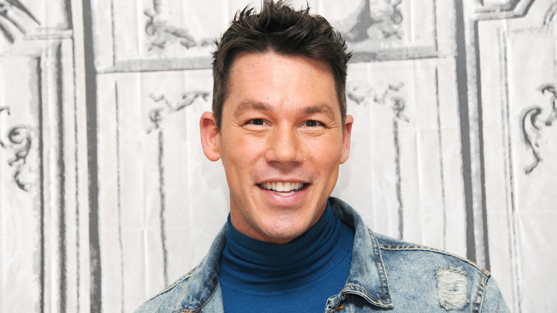 A close up of David Bromstad smiling.