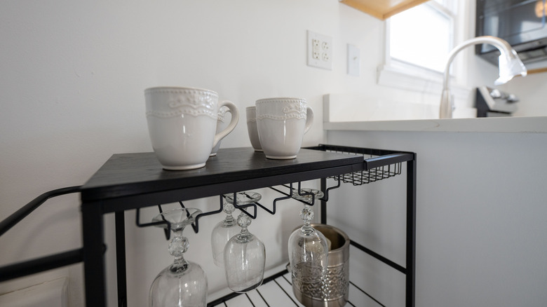 Bar cart in a kitchen with mugs on it