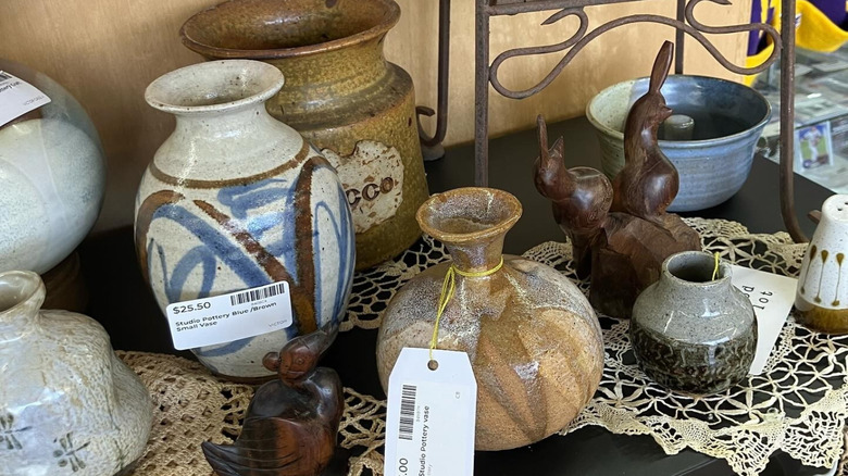 A collection of eclectic studio pottery in a secondhand shop