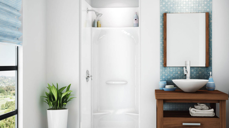 White shower pod installed in a bathroom