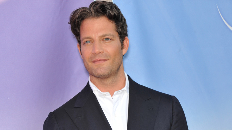 Nate Berkus poses against a lavender backdrop.