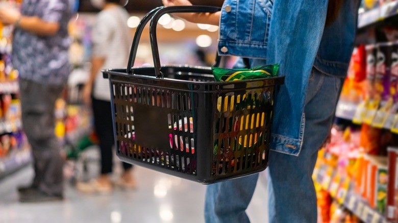 Woman carrying a shopping basket