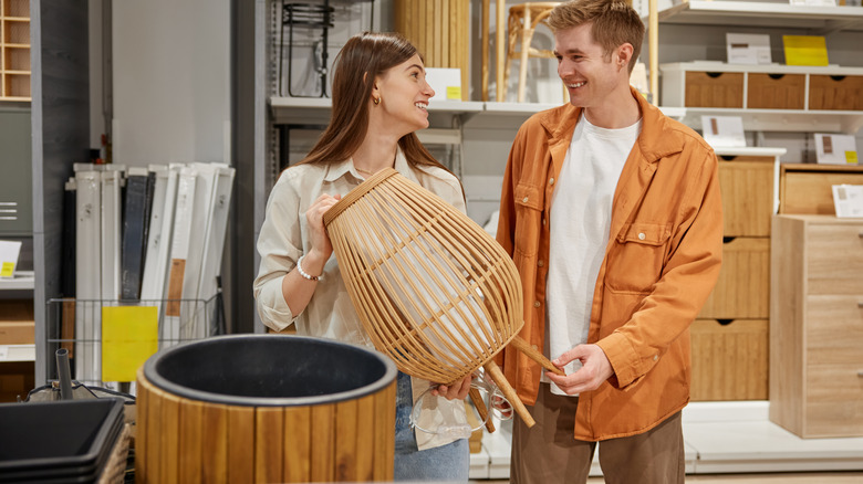 Cheerful man and woman couple shopping for furniture