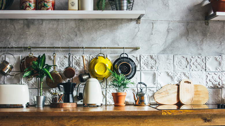 A rustic kitchen with hanging pots and pans.