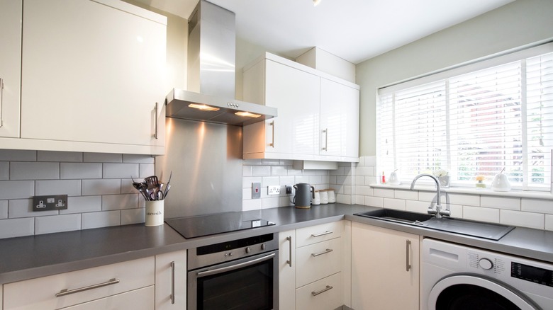 stainless steel chimney range hood in white kitchen
