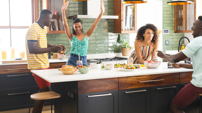 Group of friends enjoying cooking together in the kitchen