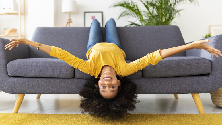 Woman upside down on couch