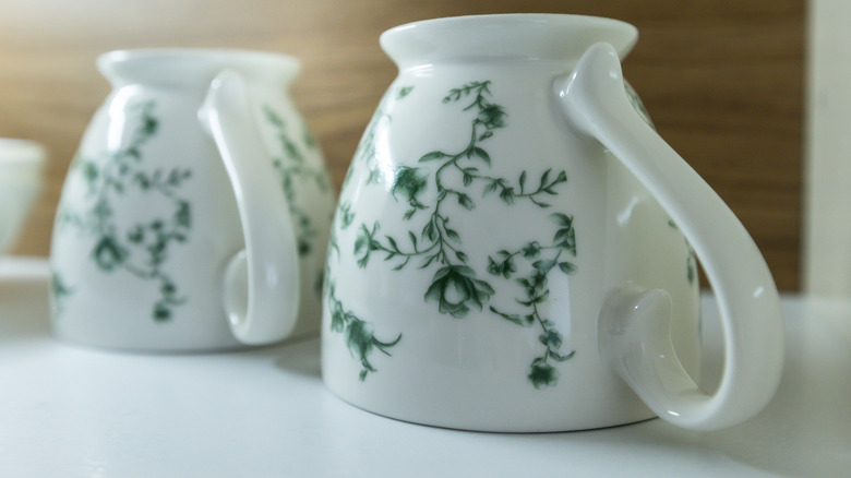 Cups upside down on a shelf