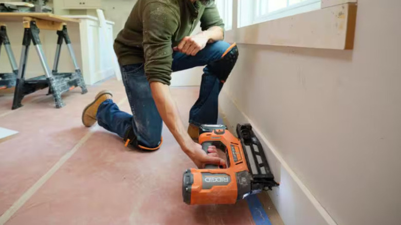 A person is using a Ridgid nail gun