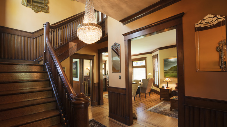 Interior foyer of a Victorian-era home with wood moldings and ornate decor