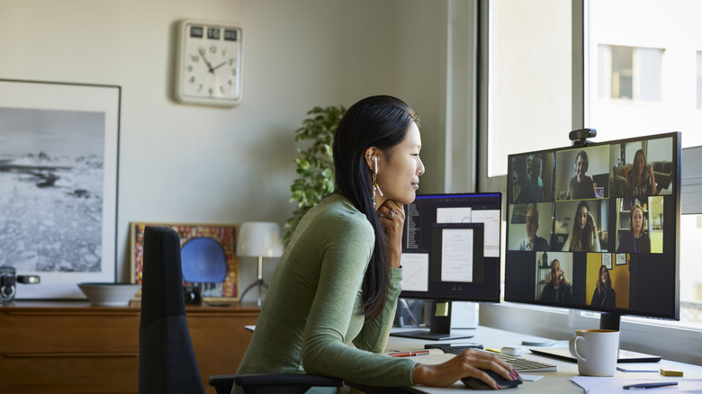 Woman sitting at desk in home office, smiling for a virtual meeting