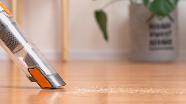 cleaning floor with vacuum attachment