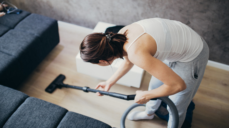 woman vacuuming vinyl floor 