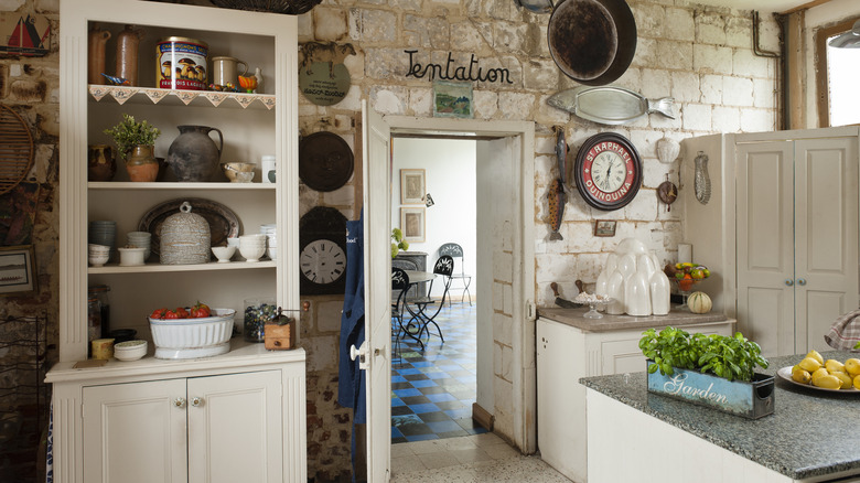 rustic kitchen with vintage dishware in cabinet