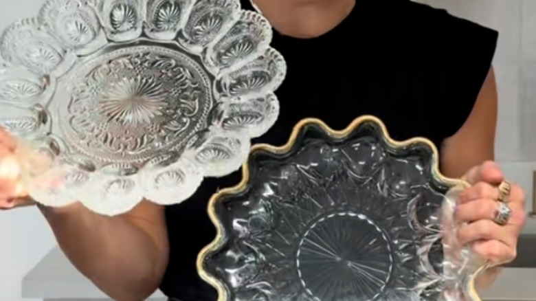 person holding vintage glass egg trays