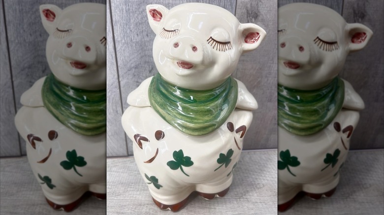 A Shawnee Smiling Pig with clover leaves and a green scarf