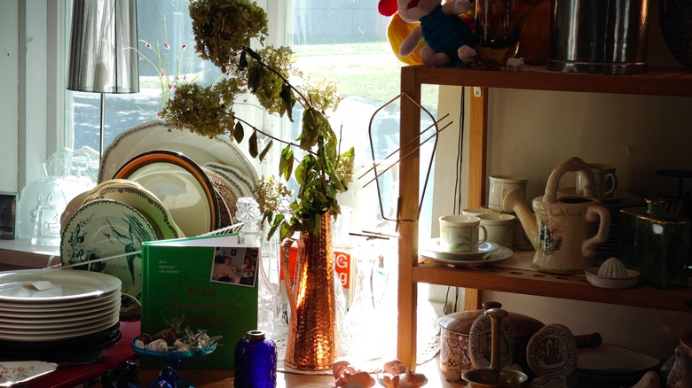 Thrift store decor aisle display with various ceramic and antique designs