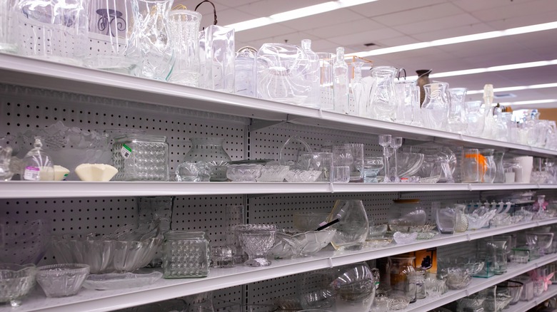 A thrift store aisle full of glassware.
