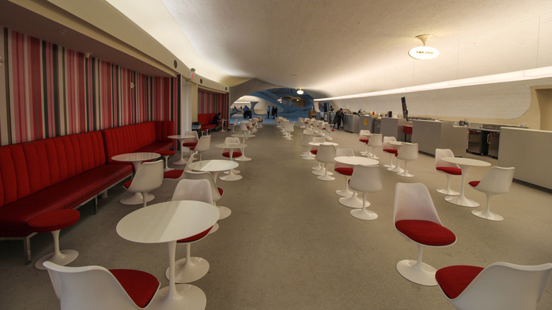 Eero Saarinen white tulip tables with white and red tulip chairs in JFK airport