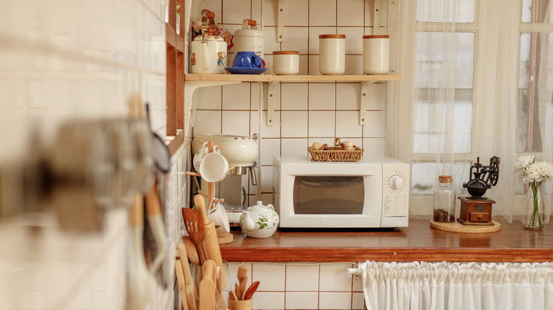 A wood and white kitchen featuring vintage items