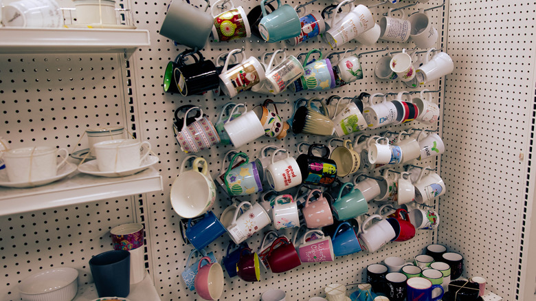 Coffee mugs on hangers at the thrift store