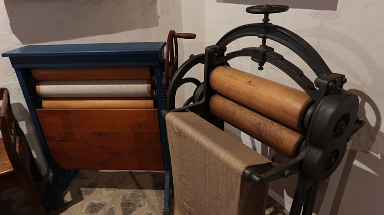 Two vintage clothes wringers in home