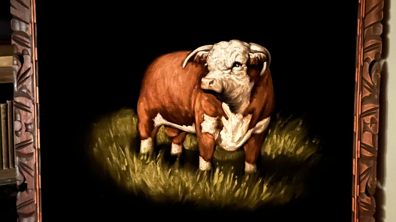 Framed painting featuring a bull