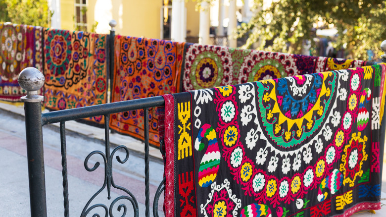 traditional suzani carpets in outdoor market