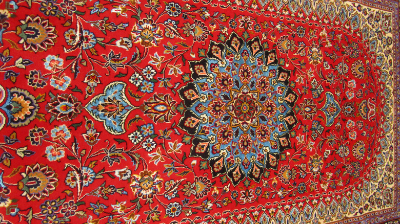 A vintage red medallion rug with intricate patterns.