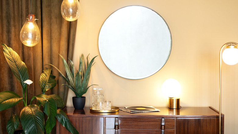 The top of a credenza styled with assorted contemporary decor items.