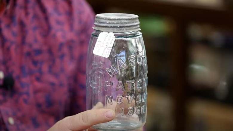 Man holds a John Landis Mason patented first Mason jar 1858