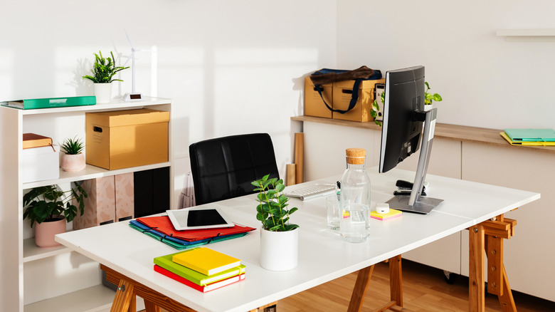 modern and clean office space with white desk and black chair