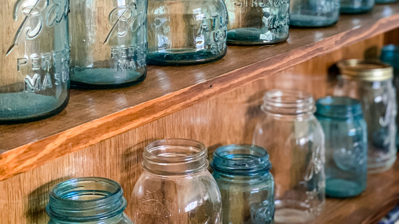 collection of empty mason jars on shelf