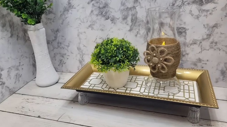 A customized Dollar Tree charging plate on a wooden table.