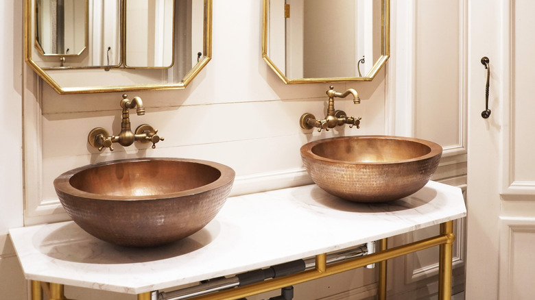 his and hers copper sinks in a bathroom