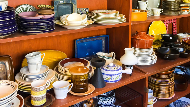 Dishware lines shelves at a thrift store