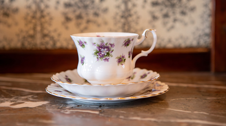 Vintage Royal Albert teacup with two saucers on a wood surface