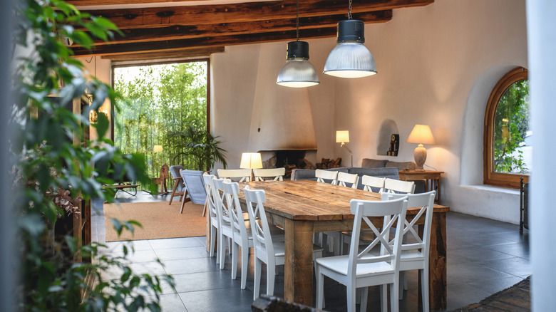 Dining room with heavy wood beans, a variety of plants, and indirect light