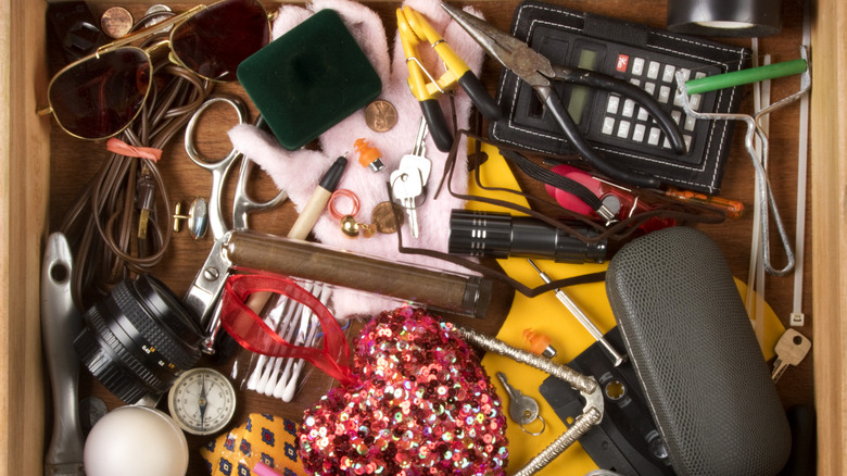 A junk drawer filled with various small items