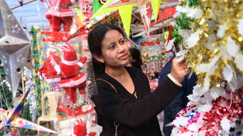 Person shopping for christmas decorations at an outdoor market