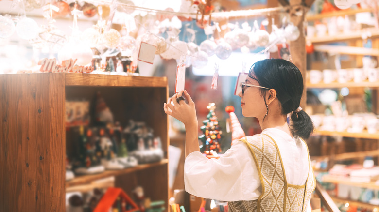 Asian woman selection decoration Christmas tree ornament at indoors market