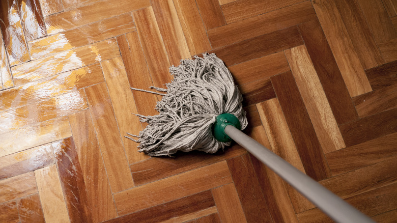 A gray mop cleaning hardwood floors.