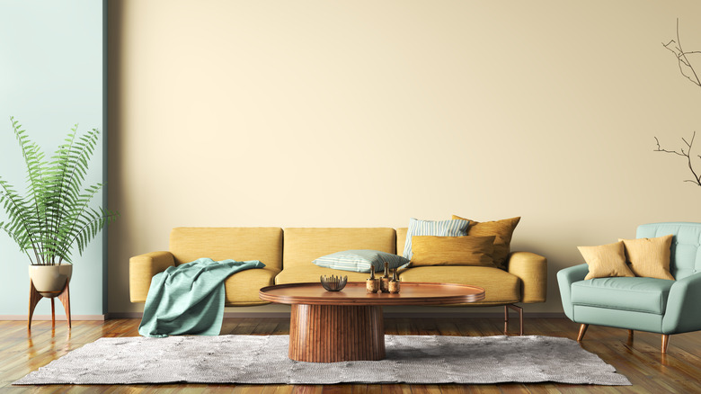 A chic living room decorated with modern furnishings and butter yellow walls