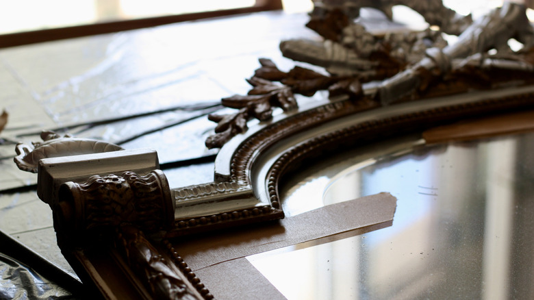 and up close view of an antique gold mirror frame