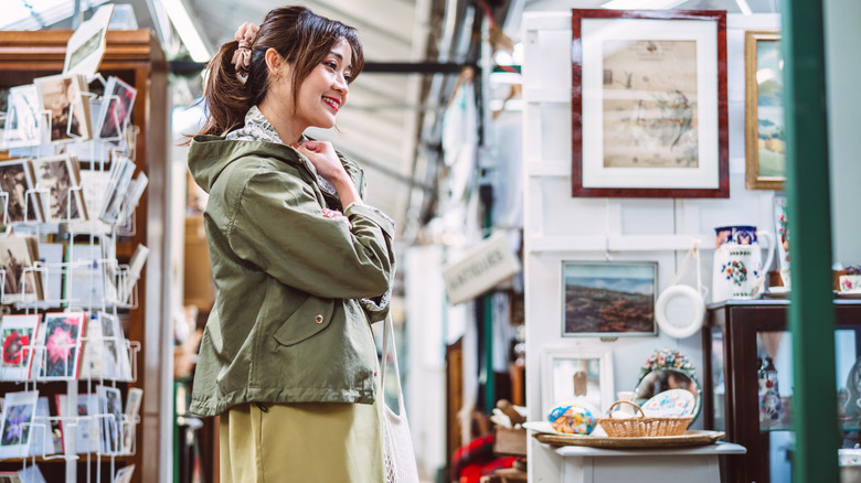 A woman shops for vintage items at a thrift store