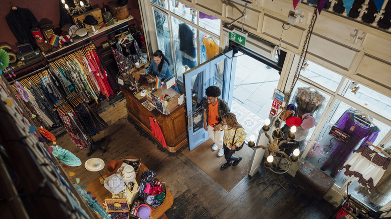 A young couple enters a secondhand store